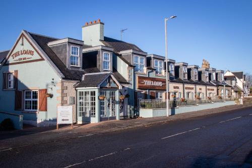 a row of buildings on the side of a street at The Loans Inn in Troon