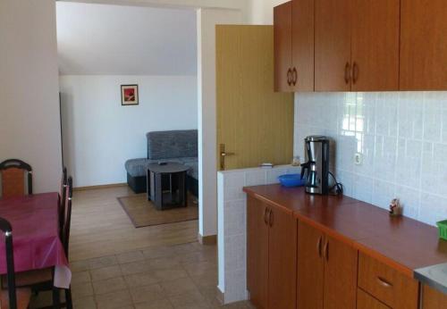 a kitchen with a counter and a room with a table at Apartment Tina in Obrovac
