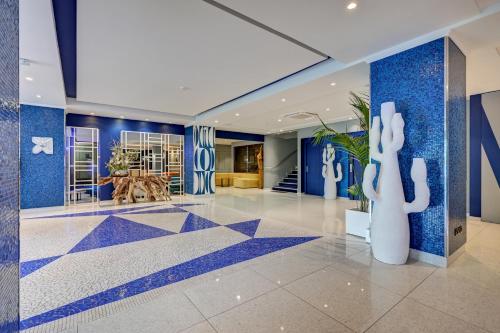 a lobby with blue walls and a blue and white floor at Juliana Hotel Cannes in Cannes