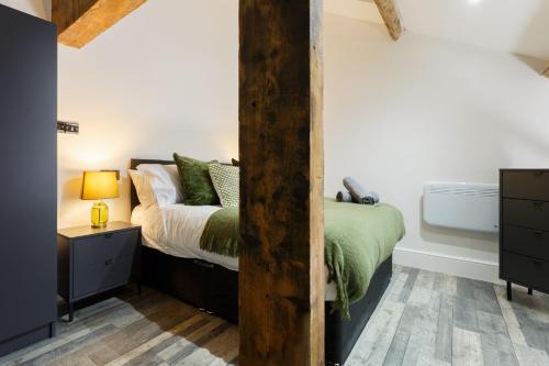 a bedroom with a bed and a bath tub at Bradford Luxury Central Apartment in Bradford