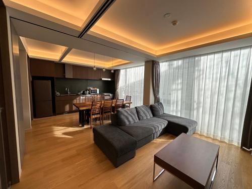 a living room with a couch and a table at SuiShou in Kutchan