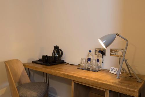 a wooden desk with a lamp and a lampost at Green Dragon, Welton by Marston's Inns in South Cave