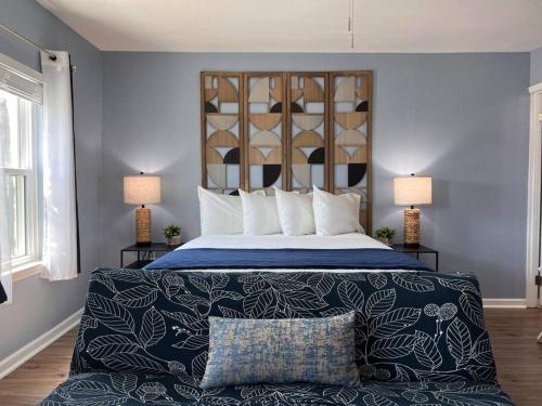 a bedroom with a bed with blue walls and two lamps at The Mark at Surfside #5 in Surfside Beach