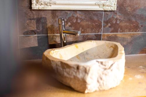 a stone sink in a bathroom with a faucet at Casa Christian in Partenen