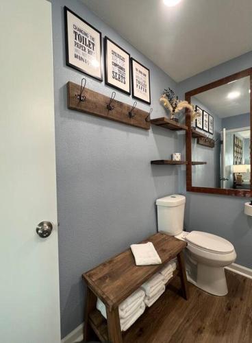 a bathroom with a toilet and a table and a mirror at The Mark at Surfside #5 in Surfside Beach