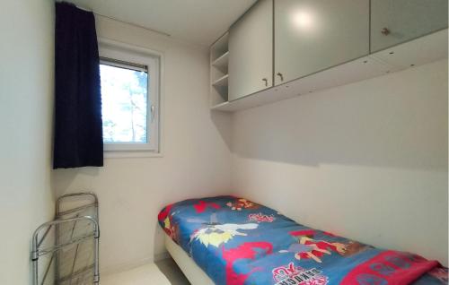 a small bedroom with a bed and a window at Stunning Home In Vorden With Wifi in Vorden