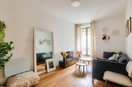 un salon avec un canapé et une table dans l'établissement Lovely 1 BR Flat near Colonel Fabien metro station, à Paris