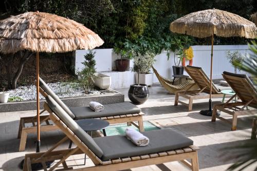 a group of chairs and umbrellas on a patio at Juliana Hotel Cannes in Cannes