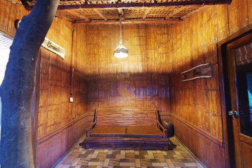 a room with a bench in a wooden wall at Mystery Maze Resort and Spa in Wayanad