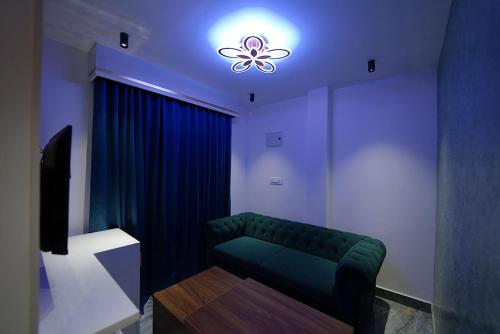 a living room with a green couch and a light at Mystery Maze Resort and Spa in Wayanad