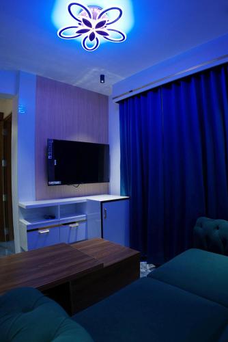 a living room with a tv and a couch and a table at Mystery Maze Resort and Spa in Wayanad