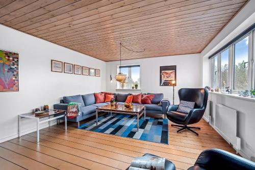 a living room with a couch and a table at Lovely Holiday House With 4 Rooms Close To The North Sea in Frøstrup