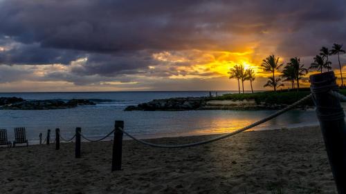 a sunset on the beach with a rope at Coconut Plantation 1110-3 in Kapolei