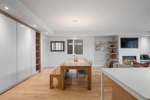 a dining room and living room with a wooden table at Lago by Tremblant Platinum in Mont-Tremblant