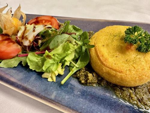 a plate of food with a salad and a sandwich at Evangelisches Allianzhaus in Bad Blankenburg