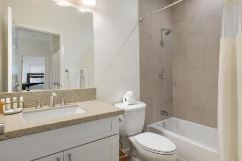 a bathroom with a sink and a toilet and a tub at Coconut Plantation 1078-3 in Kapolei