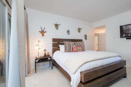 a bedroom with a bed with a wooden headboard at Wildflower 650 in Sun Valley