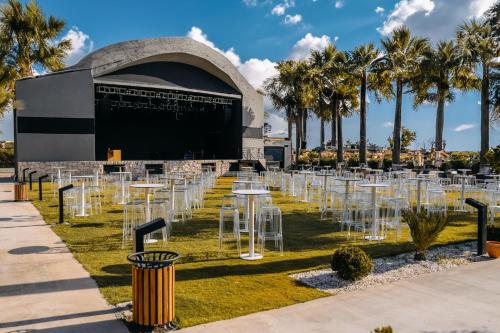 a row of tables and chairs in front of a building at Prive Hotel Didim - Ultra All Inclusive in Didim