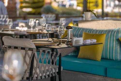 a table with a blue couch and chairs at a restaurant at Prive Hotel Didim - Ultra All Inclusive in Didim