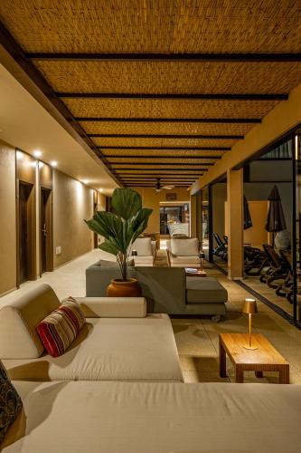 a living room with several couches and a table at Pousada Yamandu - Piscinas Aquecidas in Juquei