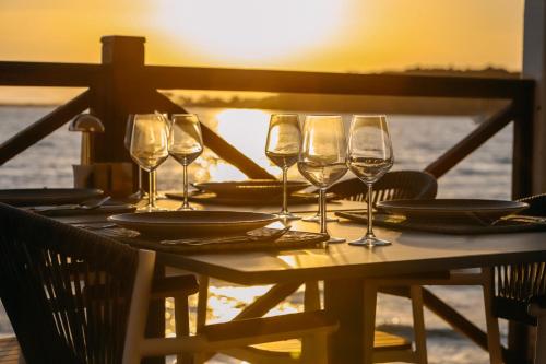 a table with wine glasses and plates on it at Prive Hotel Didim - Ultra All Inclusive in Didim