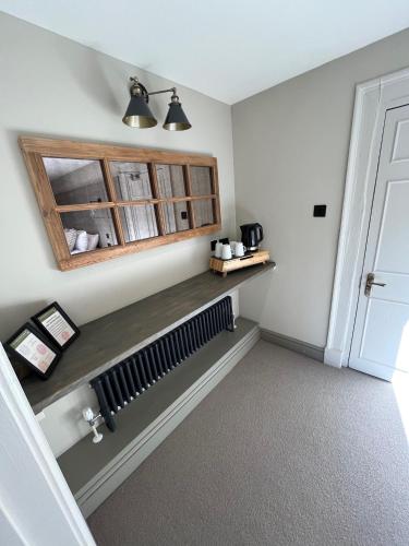 a room with a radiator and a shelf and a door at The Punchbowl Inn in Woodstock