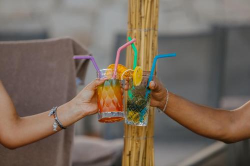 a person holding a drink in their hands at Prive Hotel Didim - Ultra All Inclusive in Didim