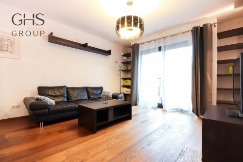 a living room with a couch and a table at Beautiful apartment in the city center, Angel City in Kraków
