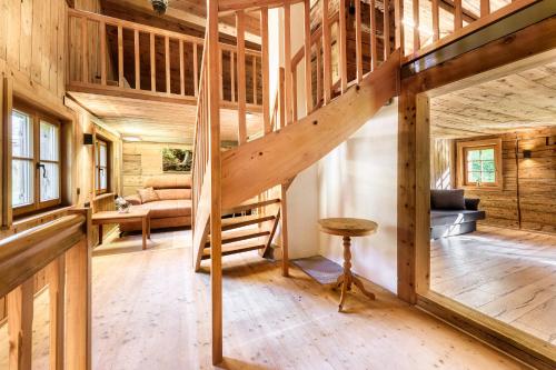 a large room with a staircase in a wooden house at Berghaus Lutzklang in Raggal