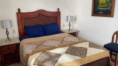 a bedroom with a large bed with blue pillows at Condominio Privado Villas Marlin Zona Hotelera Cancun in Cancún