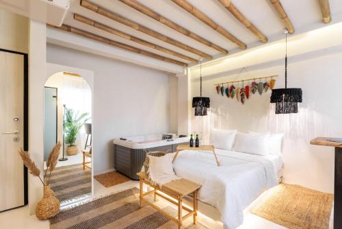 a bedroom with a bed and a table and a tub at Marabou Unique Stay in Thessaloniki