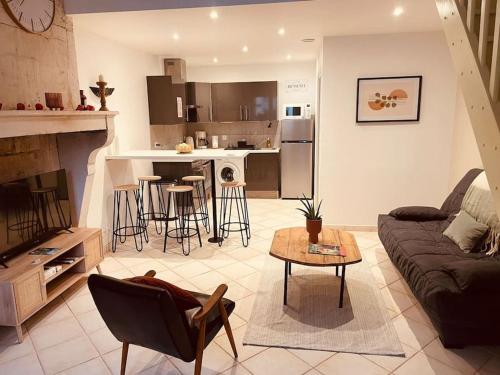 a living room with a couch and a table at La Cigogne in Châteauvillain
