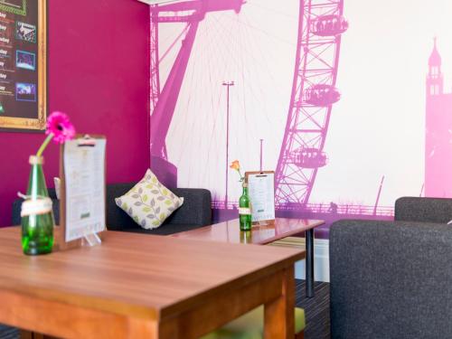 a dining room with a table and a bridge at YHA London Earl's Court in London