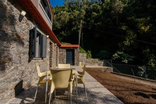 a table and chairs sitting outside of a house at GuestReady - Tranquil Hideaway near Funchal in Funchal