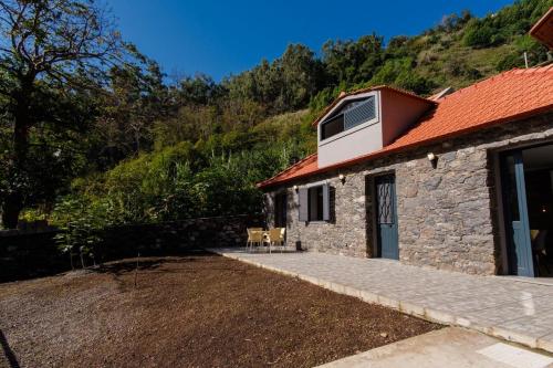 a small stone house with a red roof at GuestReady - Tranquil Hideaway near Funchal in Funchal