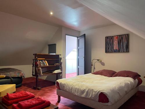 a bedroom with a large bed and a staircase at Maison bonheur proche GIVERNY et top pour télétravail in Haute-Isle