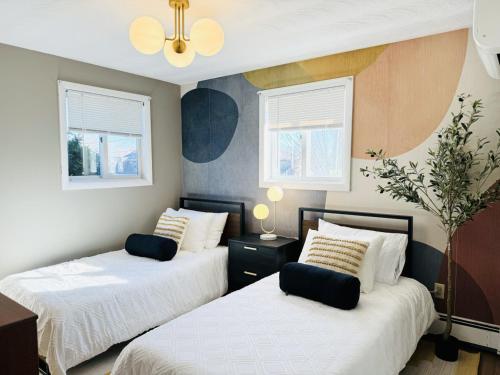 a bedroom with two beds and two windows at Spacious Poolside Boston Stay Sleeps 8 Pet Friendly in Framingham