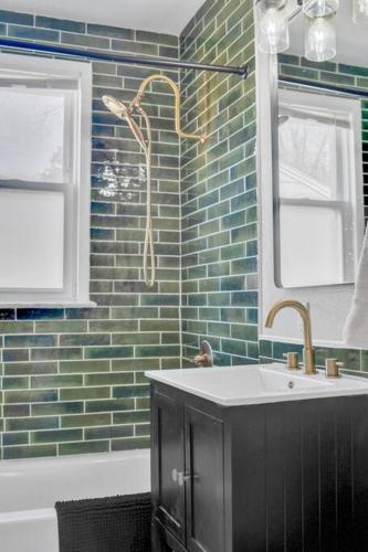 a bathroom with a tub and a sink and a mirror at Traveler's Place of Belleville in Belleville