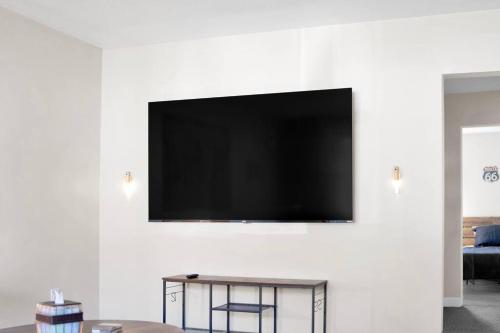 a flat screen tv hanging on a wall at Traveler's Place of Belleville in Belleville
