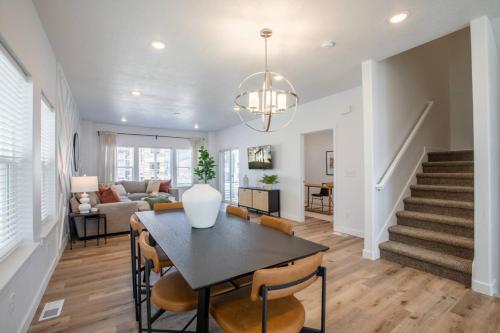 a dining room and living room with a table and chairs at Canyon Escape Luxury Ski home American Fork in American Fork