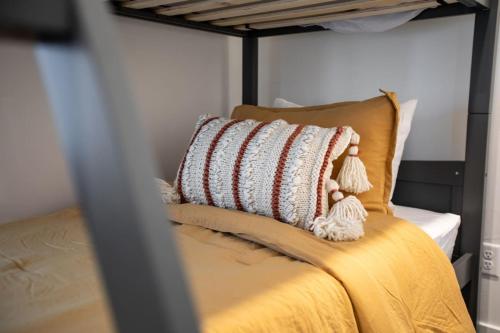 a bed with a pillow on top of it at Canyon Escape Luxury Ski home American Fork in American Fork
