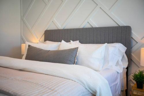 a bedroom with a bed with white sheets and pillows at Canyon Escape Luxury Ski home American Fork in American Fork