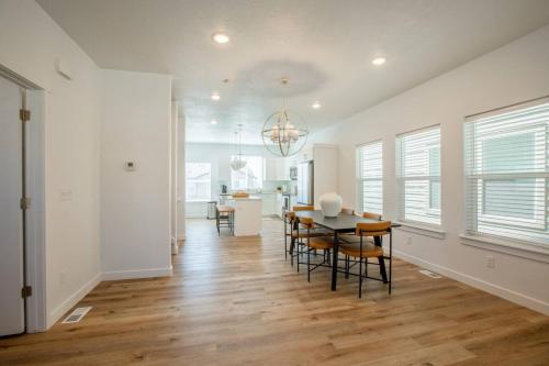 a dining room and living room with a table and chairs at Canyon Escape Luxury Ski home American Fork in American Fork