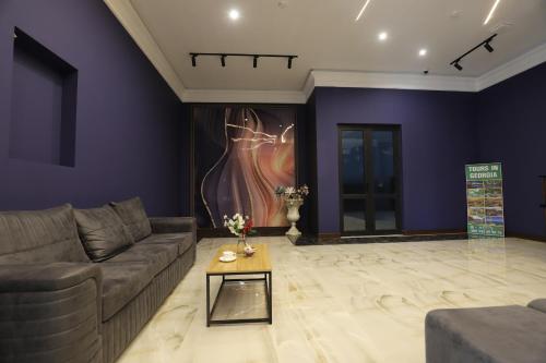 a living room with a couch and a table at Green Hotel Tskaltubo in Tskaltubo