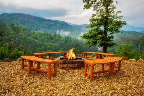 three benches and a fire pit with a view at Bella Vista Lodge in Gatlinburg