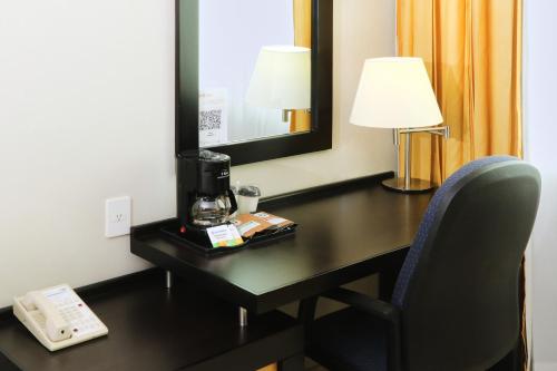 a room with a desk with a coffee maker on it at Holiday Inn Express Ciudad Del Carmen by IHG in Ciudad del Carmen