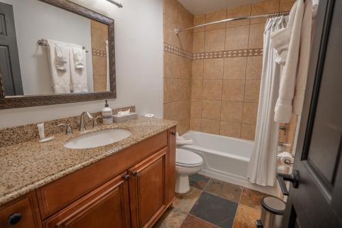 a bathroom with a sink and a toilet and a tub at Treasure Mountain Inn in Park City