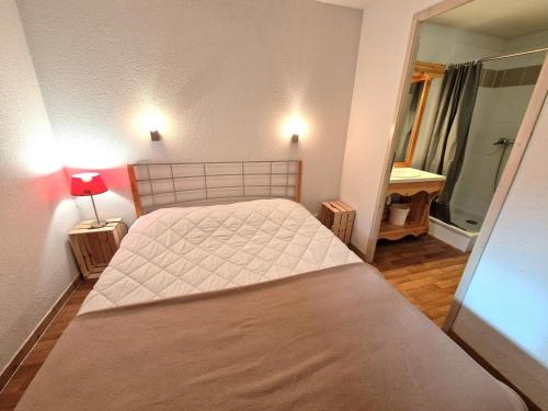 une petite chambre avec un lit et un miroir dans l'établissement Confort pour 6/8 pers, près télécabine, terrasse - FR-1-265-369, à Modane