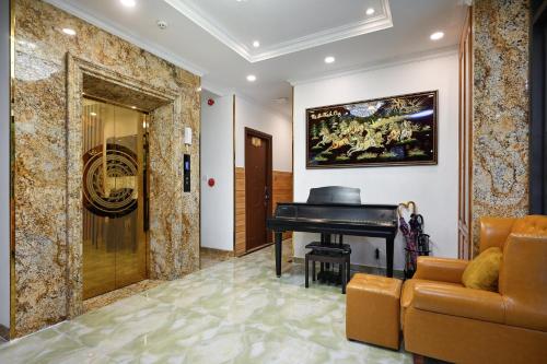 a living room with a piano and a couch at Ly Ly Hotel 2 Binh Tan District in Ho Chi Minh City