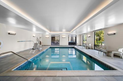 an indoor pool with blue water in a house at Hilton Garden Inn North Conway in North Conway